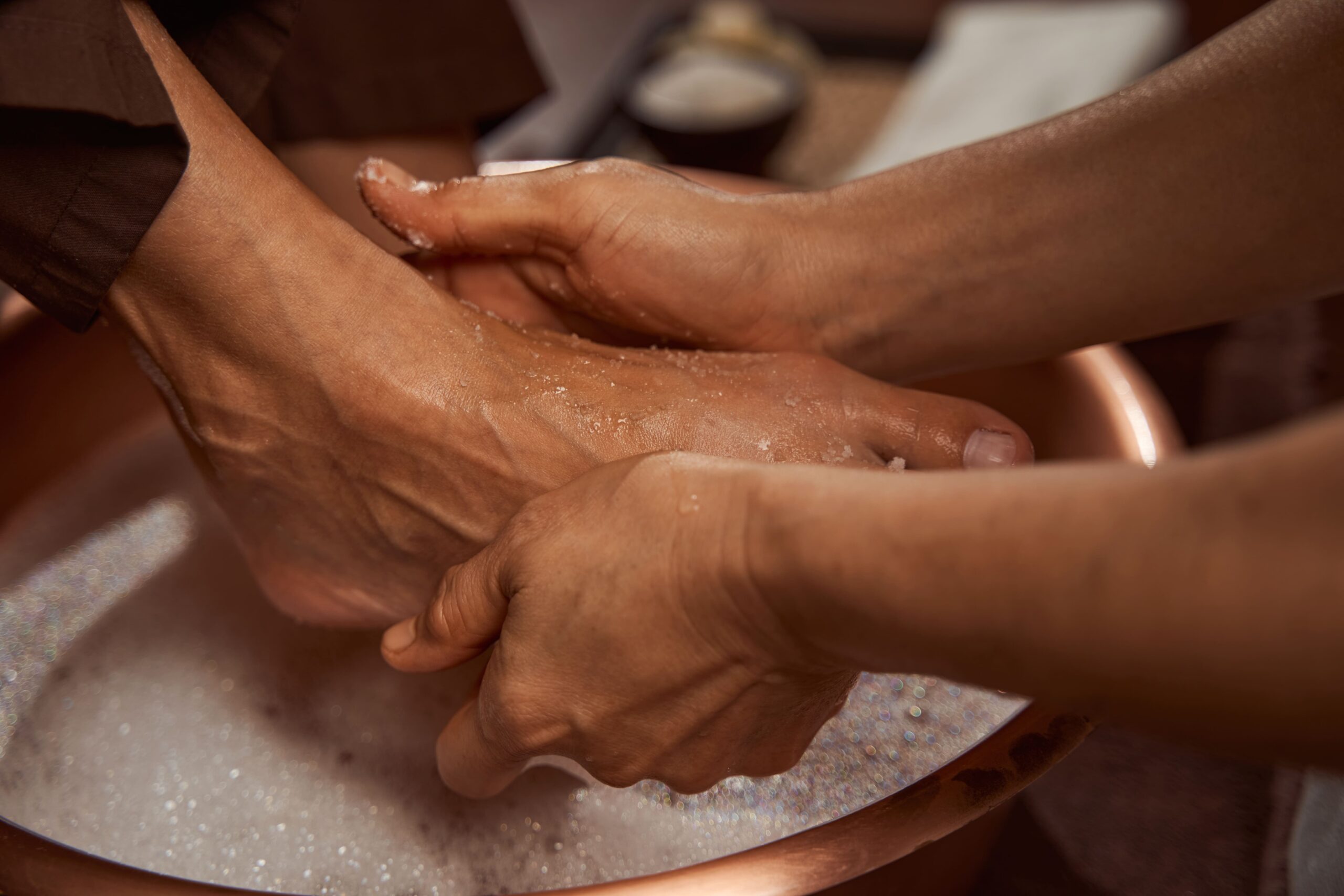 beauty-salon-worker-rubbing-her-client-feet-with soap